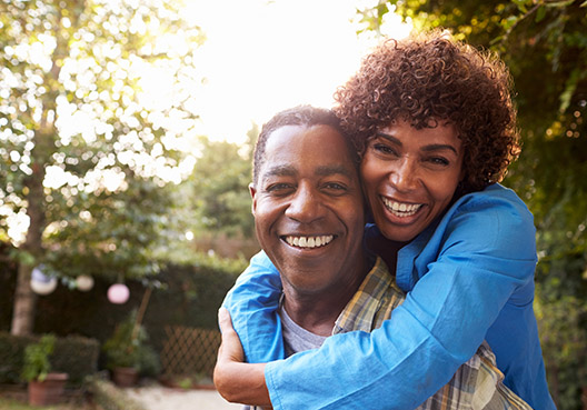 woman loving wrapping her arms around her husband woman loving wrapping her arms around her husband