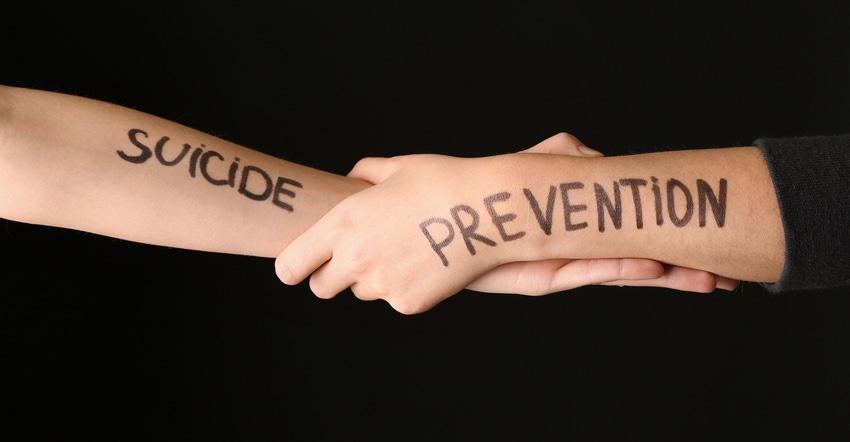 arms grasping each other with suicide prevention across each
