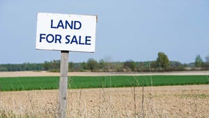 Farm fields with land for sale sign