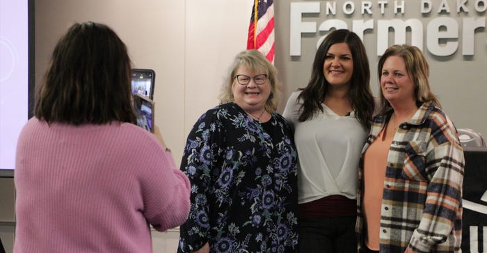 Attendants of the WILD conference visit and pose for photos with keynote speaker Michelle Miller,