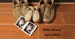Two pairs of adult shoes and one set of baby shoes with ultrasound sound pictures arranged on a wooden floor 