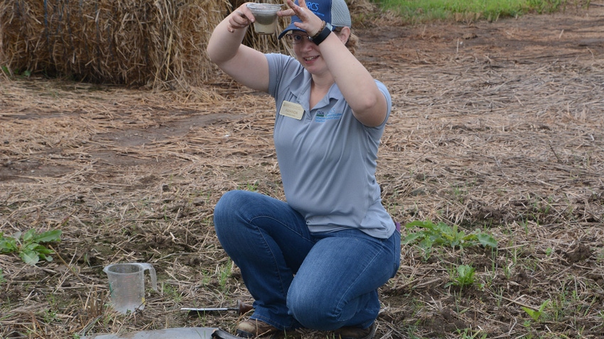 Amanda Kautz holding a container of soil