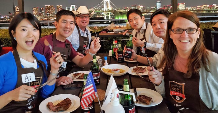 6 people enjoying beef at table 6 people enjoying beef at table