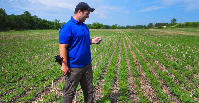 Soil scientist Patrick Chase uses tools to check on soil health