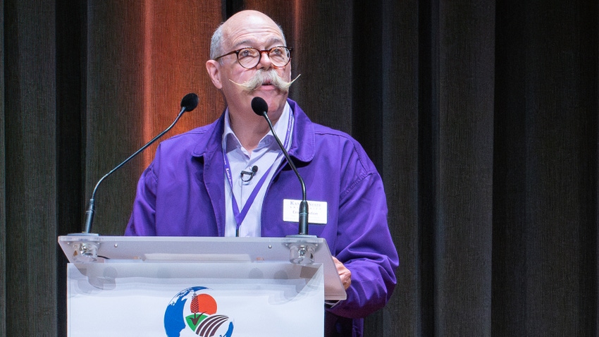 Ernie Minton, K-State dean of agriculture, speaks at podium