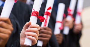 hands holding diplomas