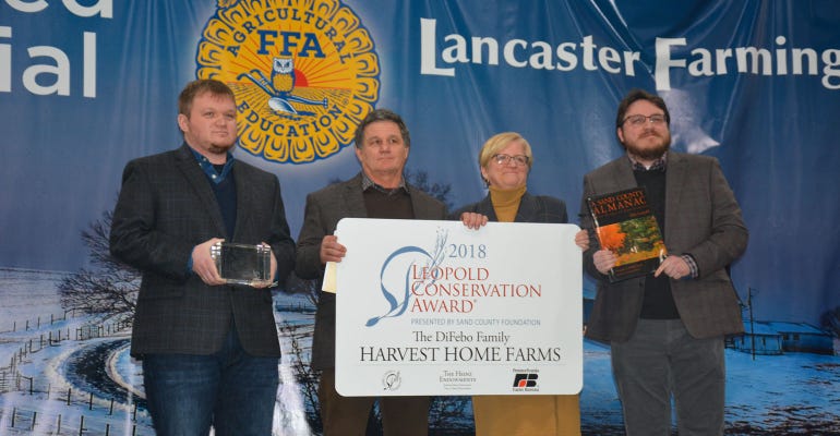 The DiFebo family accepts the Pennsylvania Leopold Conservation Award on stage at the Pennsylvania Farm Show