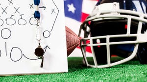Football helmet next to clip board with play diagram