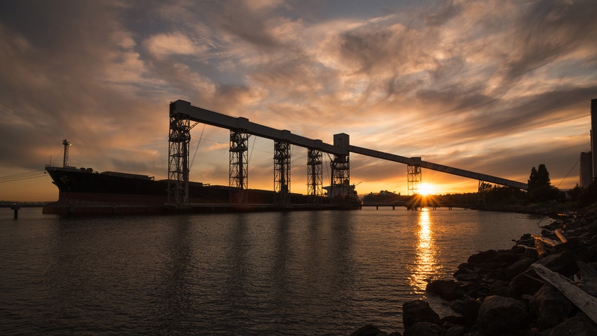 Grain ship in port at sunset