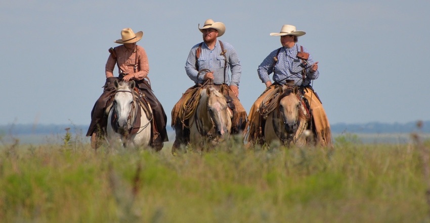 Josie, Josh and Gwen Hoy are on horseback in a tallgrass pasture on their Flying W Ranch, 