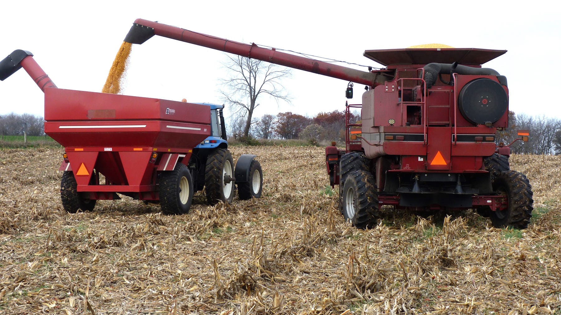 combine unloads grain into a grain cart combine unloads grain into a grain cart