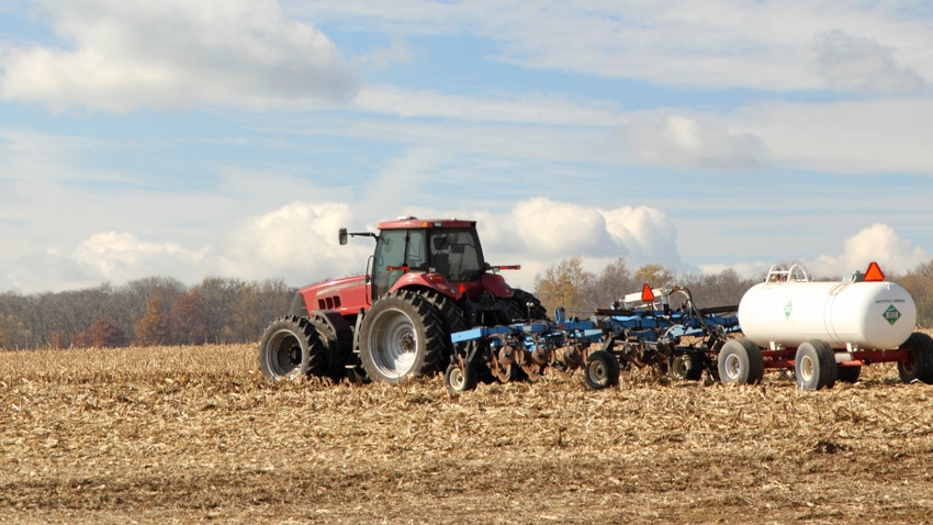 tractor plowing, fertilizing in field