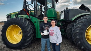John and Nancy Reiff stand in front of a tractor with a home cooked meal in hand