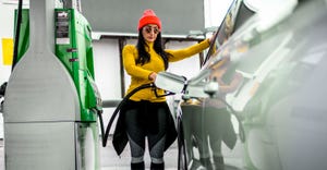 Female refueling car at gas pump