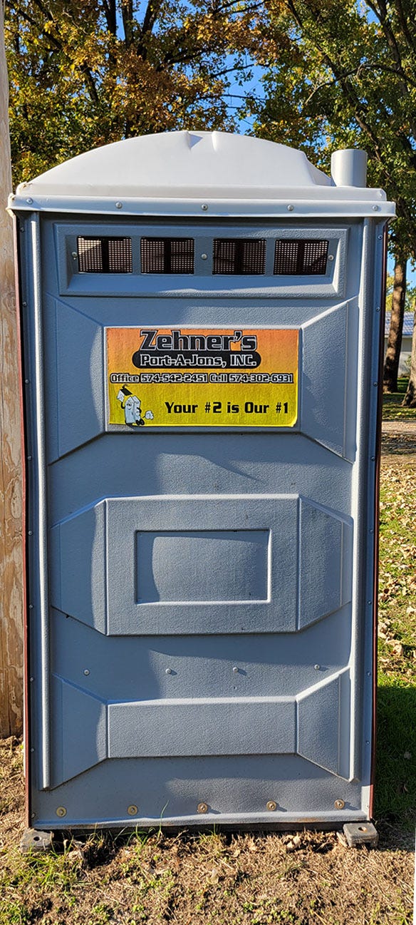 A port-a-potty with a logo that reads "Your number 2 is our number 1"