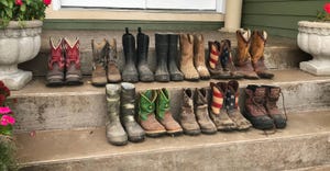 several pairs of boots lined up on steps