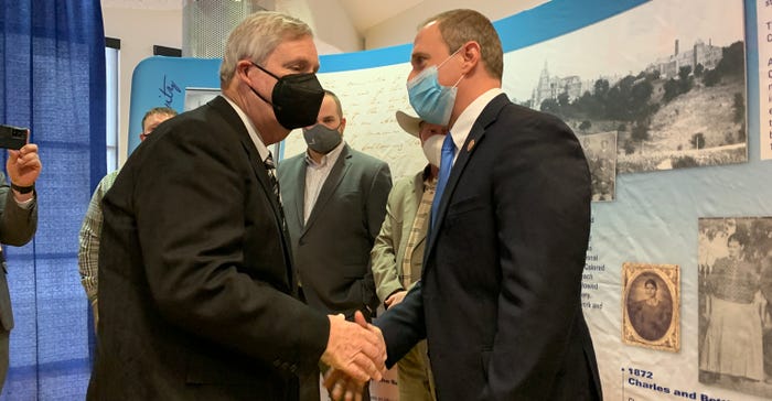 Missouri Farm Bureau President Garrett Hawkins shakes hands with Secretary Tom Vilsack 