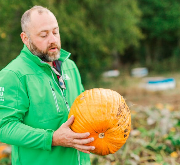 Leon Adams holds a pumpkin