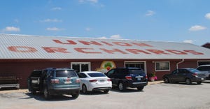 The roof at a Union Orchards building reads Union Orchards in large red letters