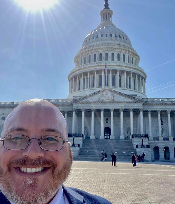 Headshot of Nate Blum in front of capitol