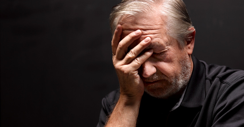 Close up of man with his head in his hands