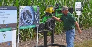Jason Webster discusses a row unit with Precision Planting’s Conceal fertilizer delivery attachment