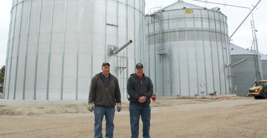 Alex and Paul Schutjer in front of a 120,000-bushel dry storage bin Alex and Paul Schutjer in front of a 120,000-bushel dry storage bin