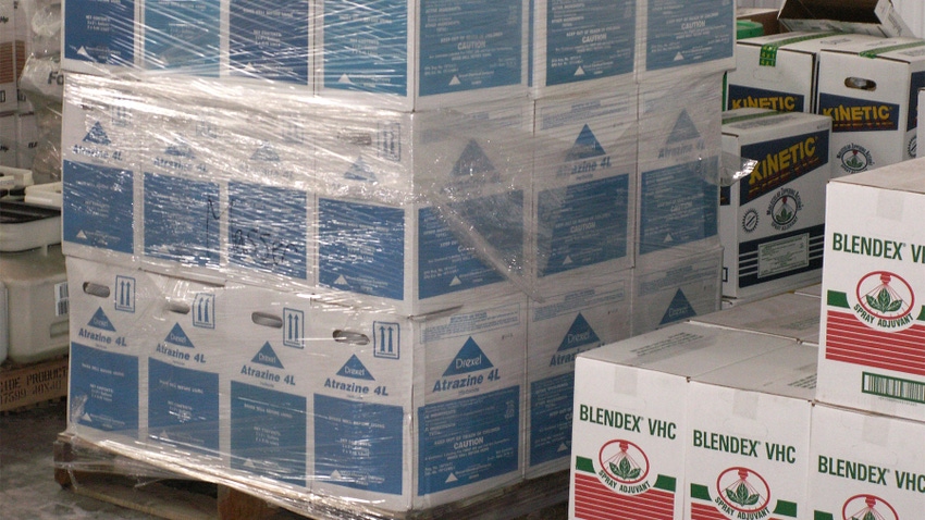Chemicals packaged in boxes and wrapped in plastic on wooden pallets