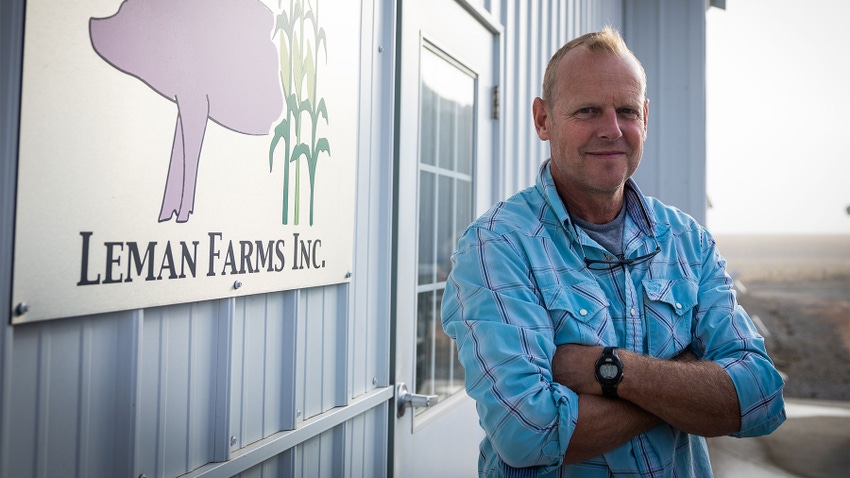 Chad Leman, Illinois Pork Producers Association president, poses next to a Leman Farms Inc. sign
