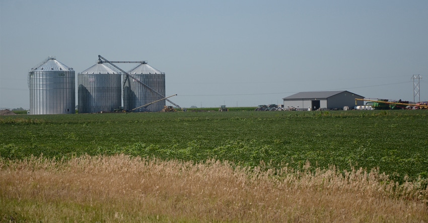 Farmland with silos in the background