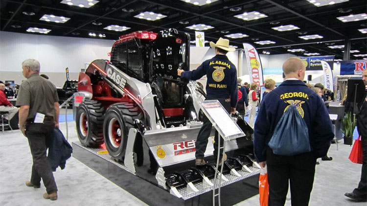 FFA members looking at a Case IH skid steer on display at a trade show