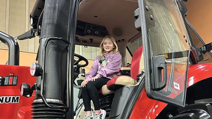 Norah Haigwood tests out a Case IH tractor on display.