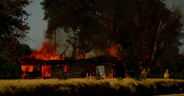 Firefighters try to keep burning home fire from spreading in Lane, Idaho, U.S.