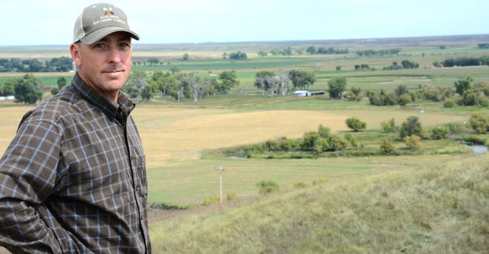 Shawn Freeland views their ranch from the bluffs above Dry Creek.