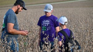 4-H students in field with farmer
