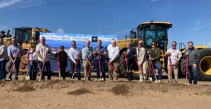Dignitaries dig the first shovelfuls of dirt at the site of the future Hilmar Cheese Co. plant in Dodge City, Kan., on Sept. 