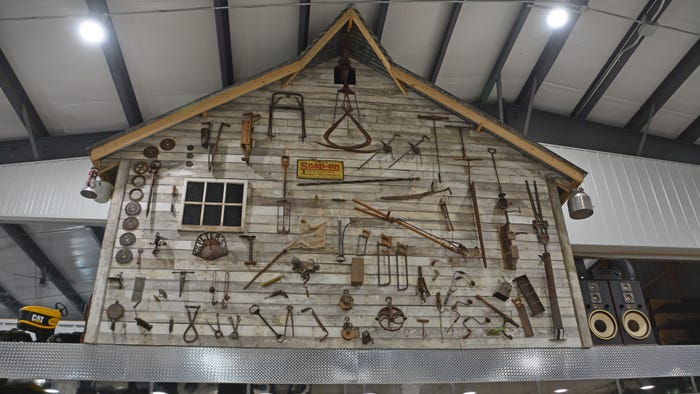 barn wall constructed of old barn wood and primitive items used on Midwestern farms