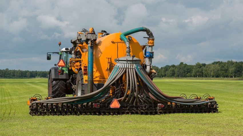 A tractor injecting liquid manure in a field