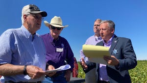 K-State President Richard Linton (far right) and farmers in Edwards County, Kan. 