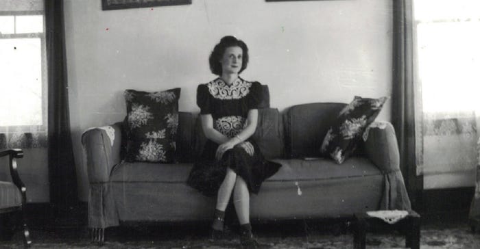 : Leona (Augustine) Luecke sitting on a couch