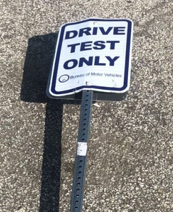 Driving Test Only sign lying on pavement