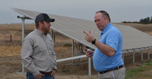 Matt Gunderson, Farmers National Company senior vice president of strategy, sales and marketing, visits with FNC farm manager