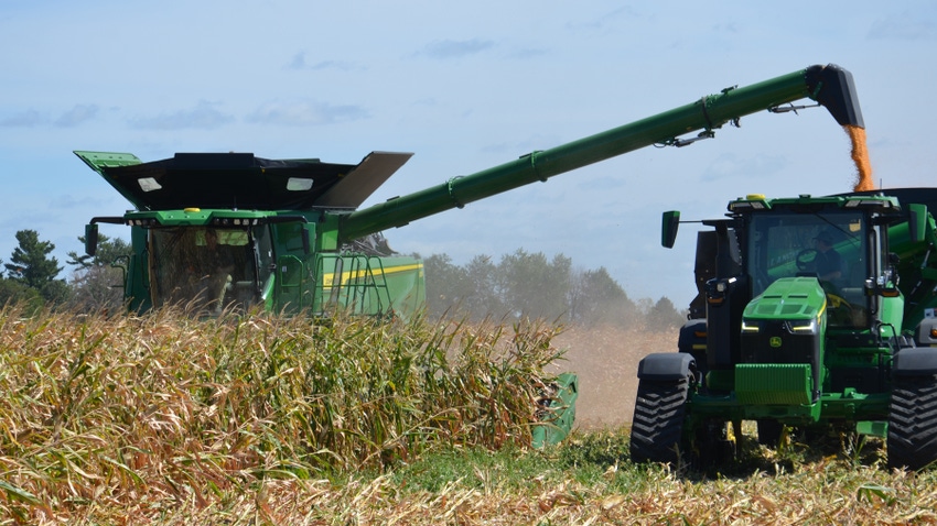 combine harvesting corn into cart
