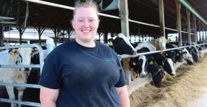 Caitlyn Degner stands outside the dairy barn at Walmoore Holsteins in West Grove, Pa.