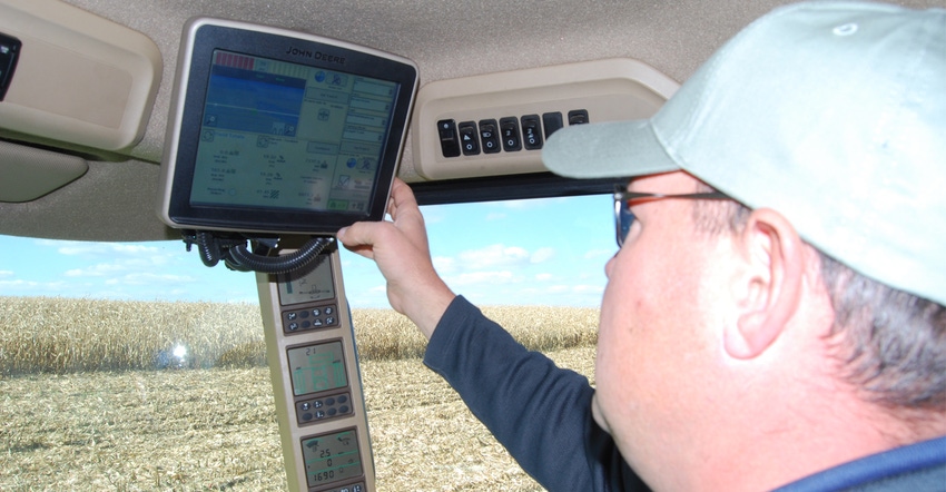tractor driving adjusting monitor in cab