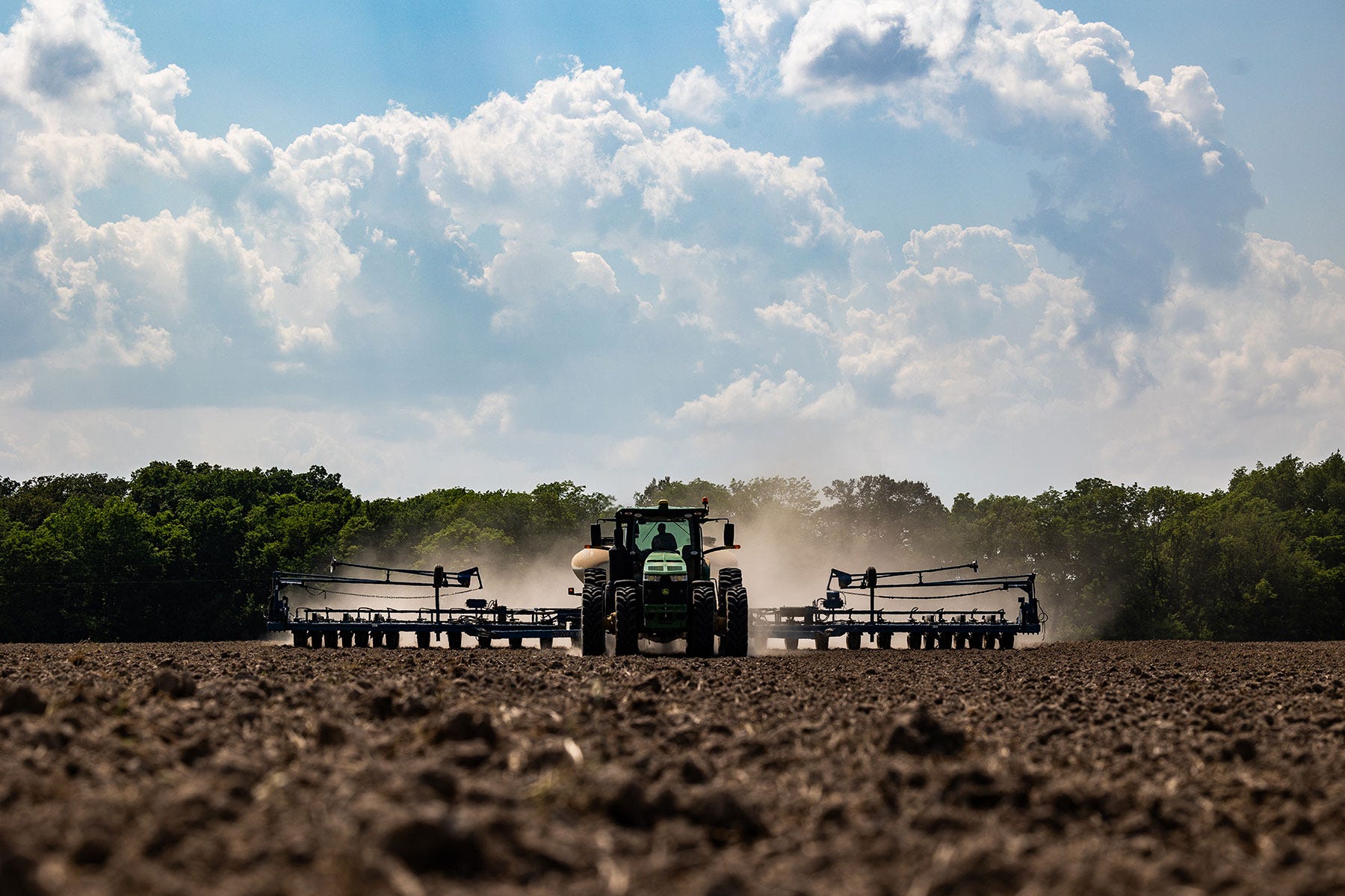 A tractor planting a field