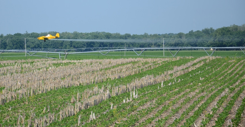 airplane spraying crop field