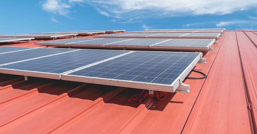 Close up of solar panels on red metal roof Close up of solar panels on red metal roof