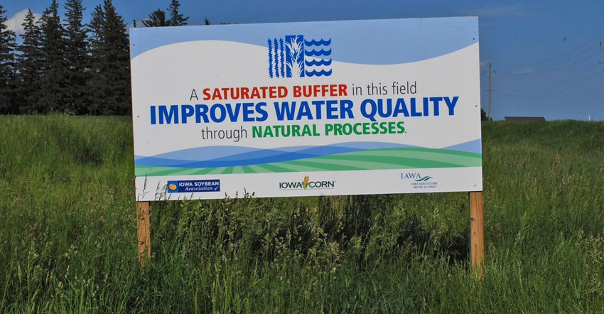 a sign promoting improved water quality in a field