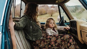 A mom and her toddler in an old pick up truck